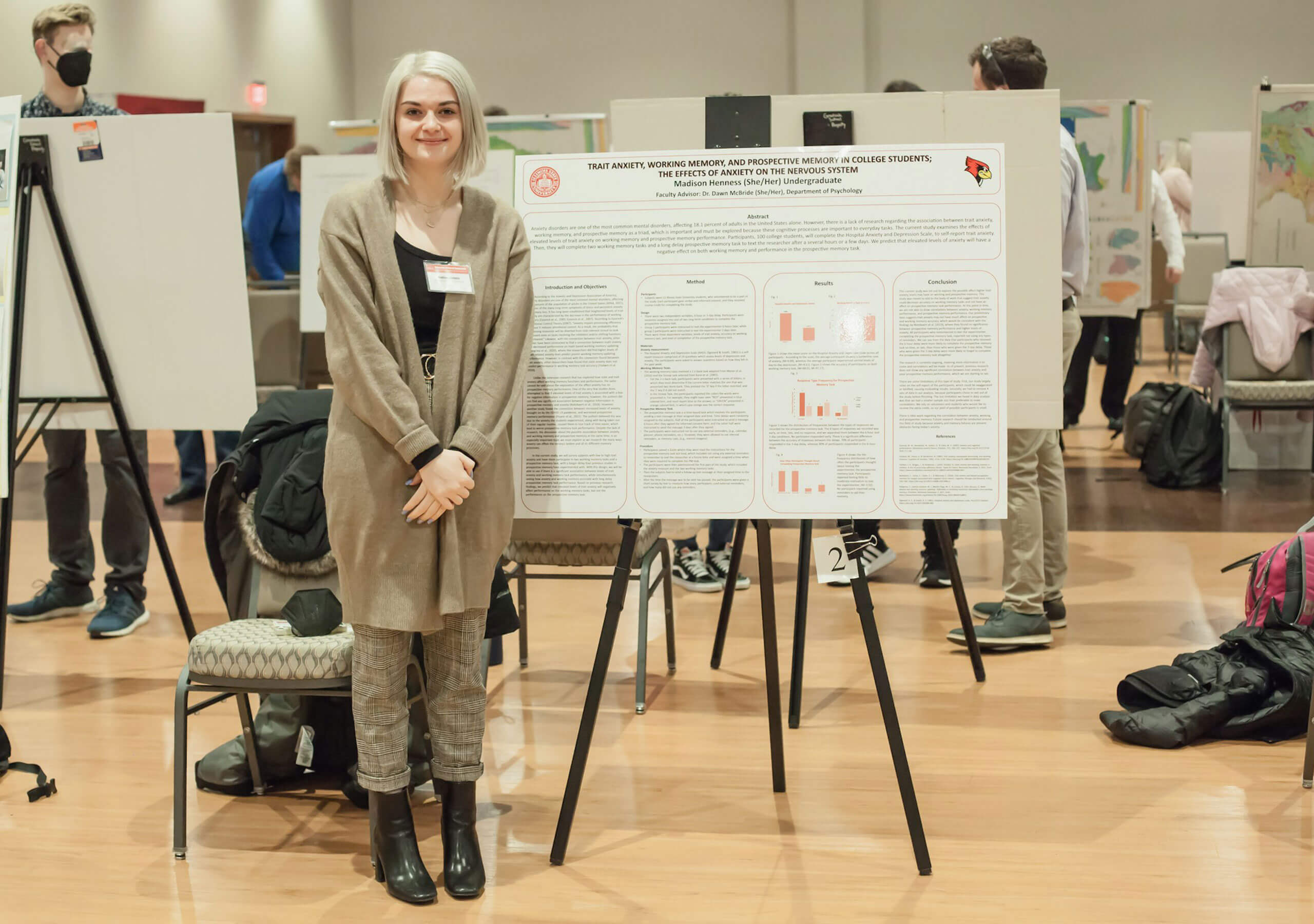 A student displaying their research poster.